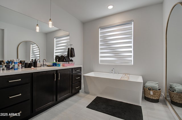 bathroom with vanity, a tub to relax in, and tile patterned floors