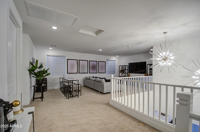 living room with a chandelier and light carpet