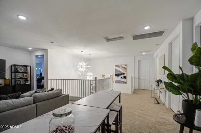 dining area featuring light colored carpet and a notable chandelier