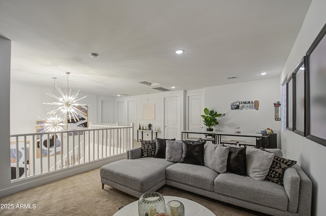 carpeted living room featuring an inviting chandelier