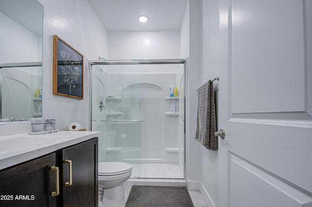 bathroom with vanity, tile patterned floors, toilet, and walk in shower