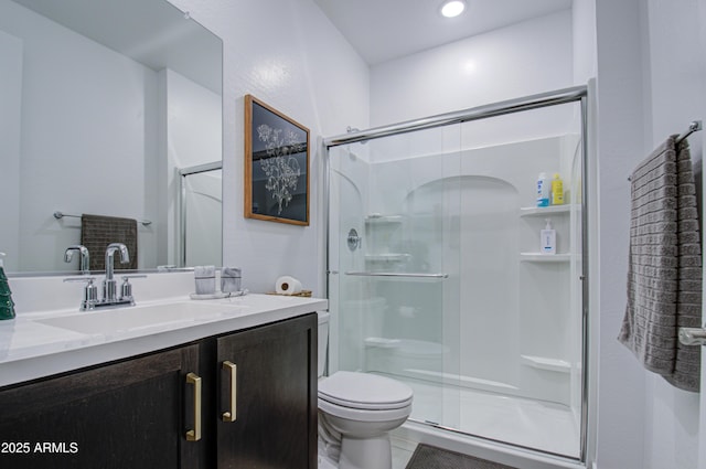 bathroom with vanity, toilet, tile patterned flooring, and a shower with door