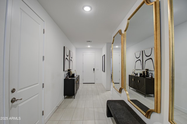 corridor with light tile patterned floors