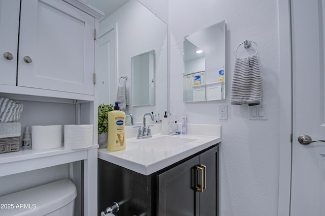 bathroom with vanity and toilet