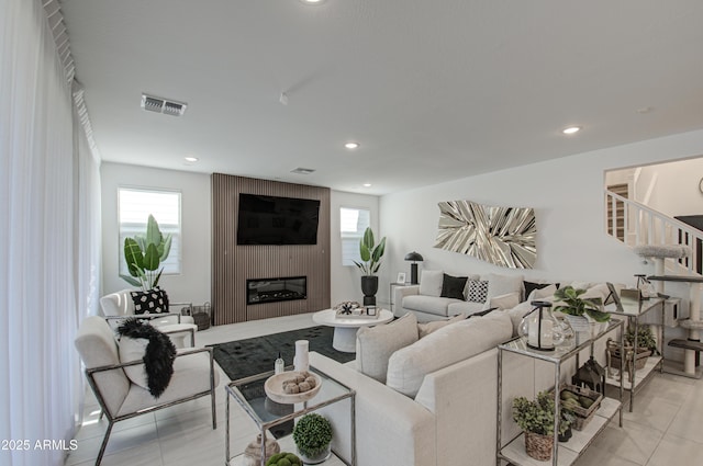 living room featuring light tile patterned flooring and a fireplace