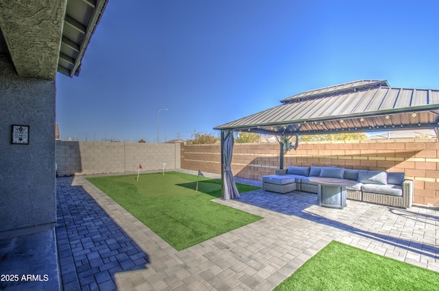 view of yard featuring a gazebo, an outdoor hangout area, and a patio