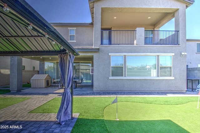 back of property with a balcony and a patio area