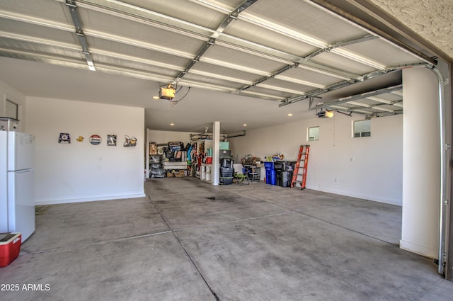 garage featuring a garage door opener and white fridge