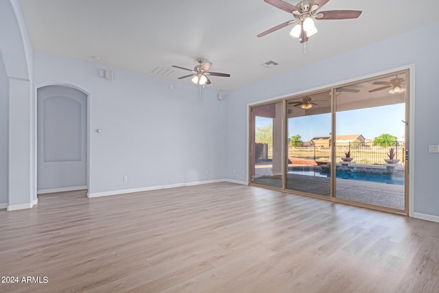 unfurnished room featuring ceiling fan and hardwood / wood-style floors