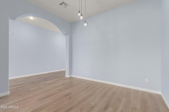 spare room featuring light wood-type flooring