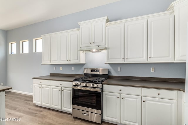 kitchen featuring stainless steel range with gas cooktop, white cabinetry, and light wood-type flooring