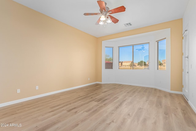 empty room featuring ceiling fan and light hardwood / wood-style flooring