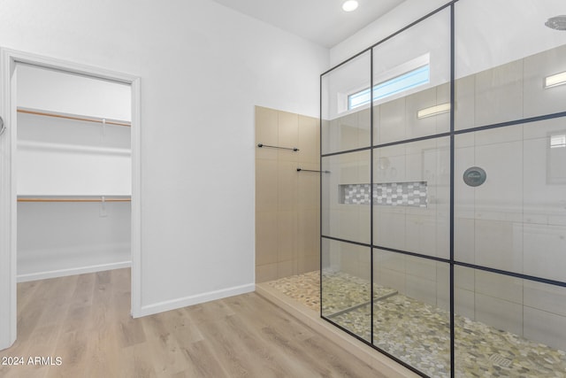 bathroom with walk in shower and wood-type flooring