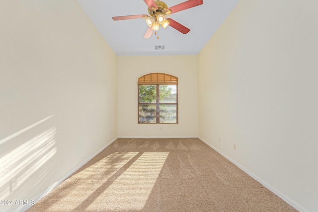 carpeted spare room with ceiling fan