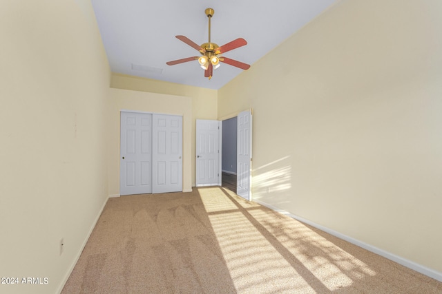 unfurnished bedroom with carpet flooring, a closet, and ceiling fan