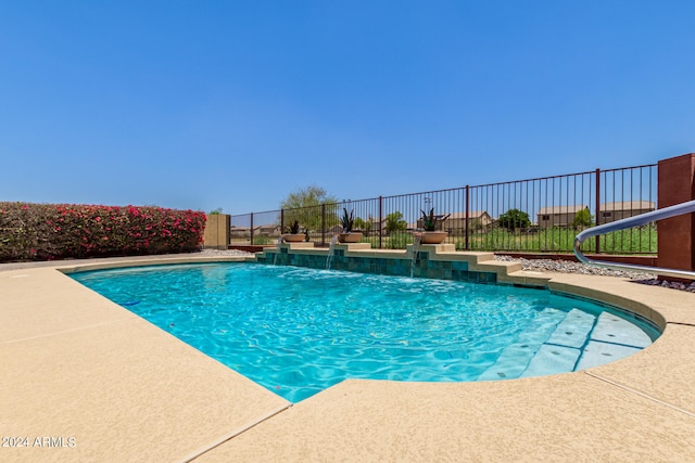 view of swimming pool with pool water feature