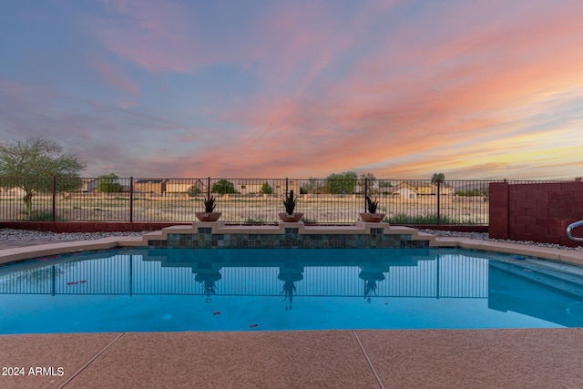 view of pool at dusk