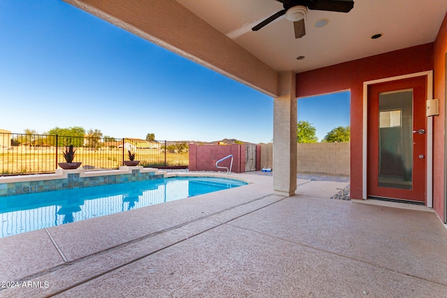 view of pool with ceiling fan and a patio area