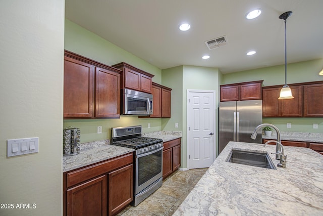6554 W Rushmore Way, Florence, AZ 85132 - kitchen featuring stainless steel appliances, decorative light fixtures, light stone countertops, recessed lighting, and dark brown cabinets