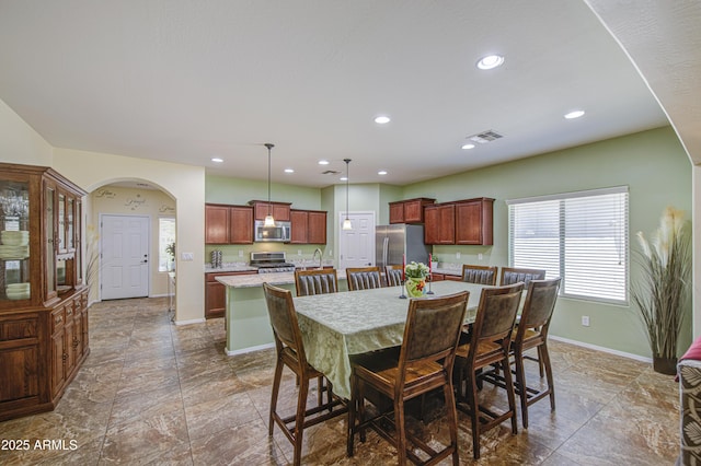 6554 W Rushmore Way, Florence, AZ 85132 - dining area featuring arched walkways and recessed lighting