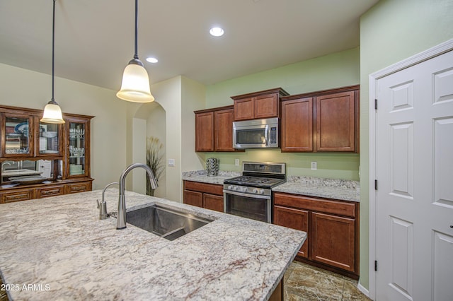 6554 W Rushmore Way, Florence, AZ 85132 - kitchen featuring appliances with stainless steel finishes, pendant lighting, light stone countertops, a center island with sink, and recessed lighting