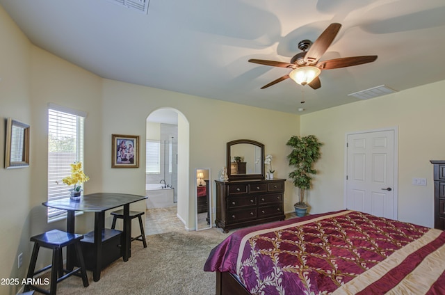 6554 W Rushmore Way, Florence, AZ 85132 - carpeted bedroom with arched walkways, connected bathroom, and a ceiling fan