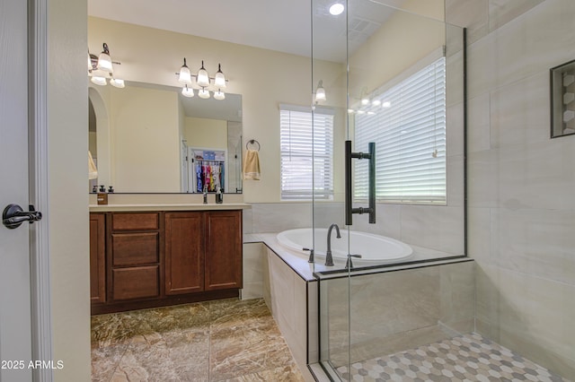 6554 W Rushmore Way, Florence, AZ 85132 - bathroom with a garden tub, vanity, tiled shower, and a walk in closet
