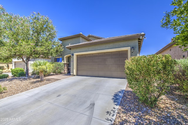 6554 W Rushmore Way, Florence, AZ 85132 - view of front of house with concrete driveway, a garage, and stucco siding