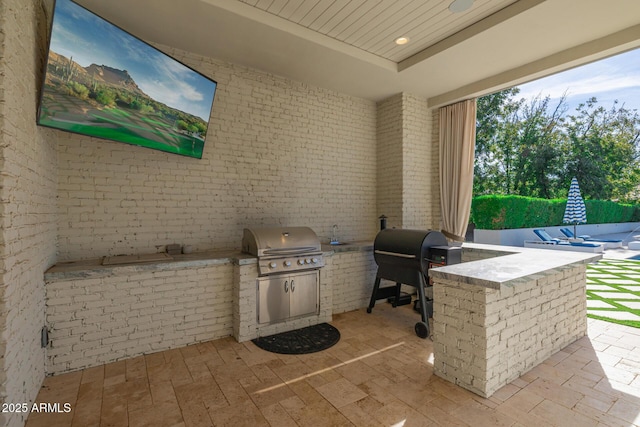 view of patio / terrace with an outdoor kitchen and area for grilling