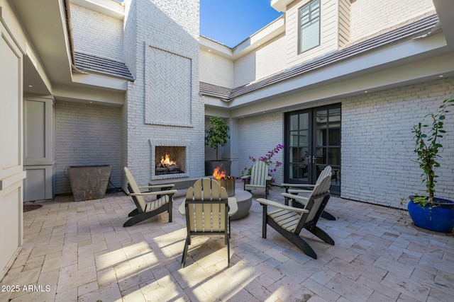 view of patio / terrace with an outdoor fireplace