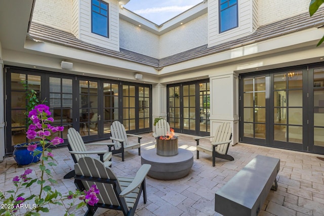 view of patio / terrace with french doors and a fire pit