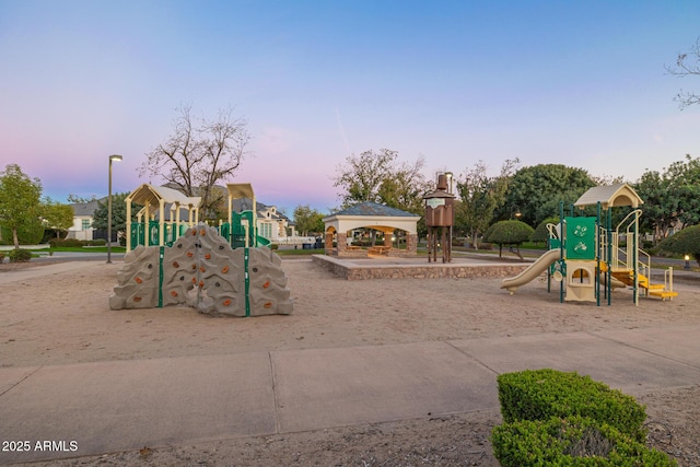 playground at dusk featuring a gazebo