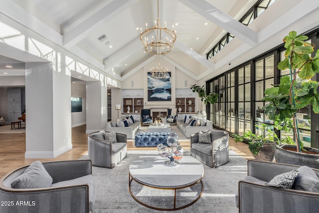 living room with an inviting chandelier, wood-type flooring, beam ceiling, and high vaulted ceiling