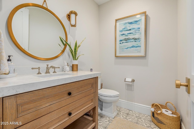 bathroom featuring vanity, tile patterned floors, and toilet