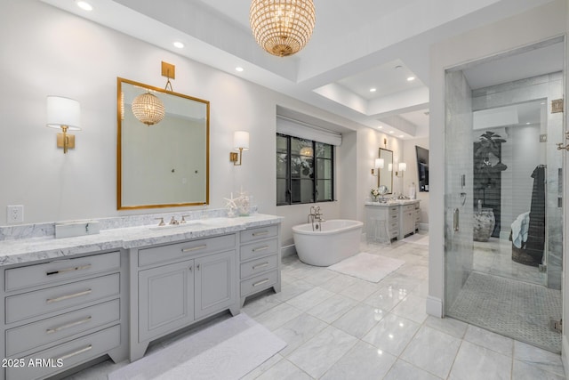 bathroom with vanity and separate shower and tub