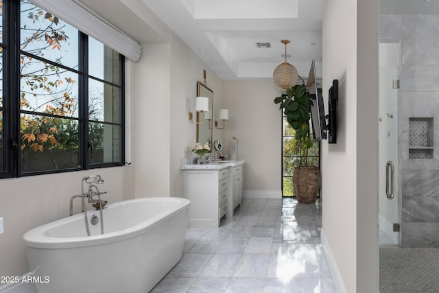 bathroom featuring vanity, shower with separate bathtub, and a tray ceiling