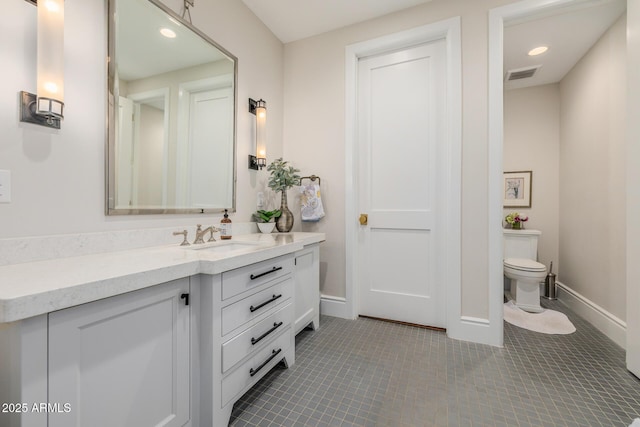 bathroom featuring vanity, tile patterned floors, and toilet