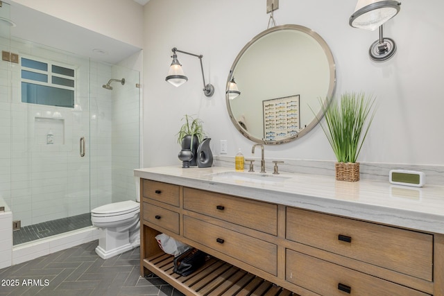 bathroom featuring a shower with door, vanity, and toilet