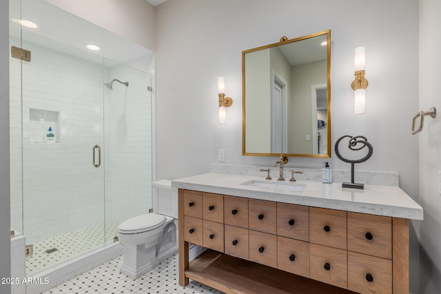 bathroom with vanity, a shower with shower door, tile patterned floors, and toilet