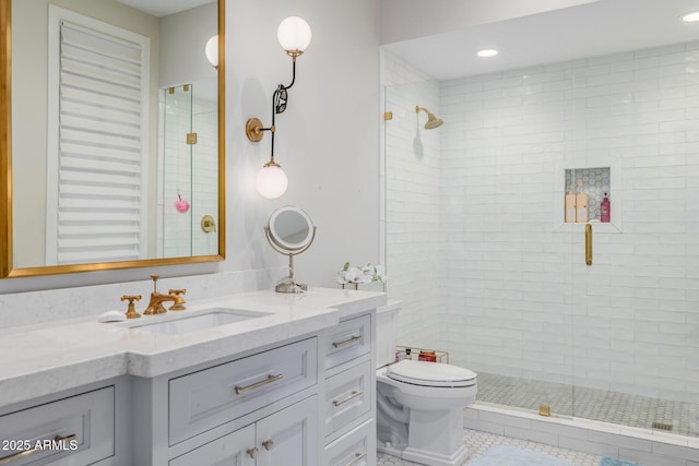 bathroom with tile patterned floors, vanity, toilet, and a shower with door