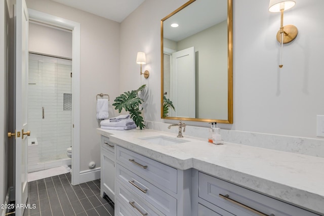 bathroom with vanity, toilet, tile patterned floors, and walk in shower