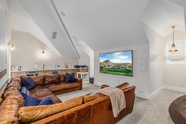 cinema room featuring vaulted ceiling, sink, light carpet, and beverage cooler