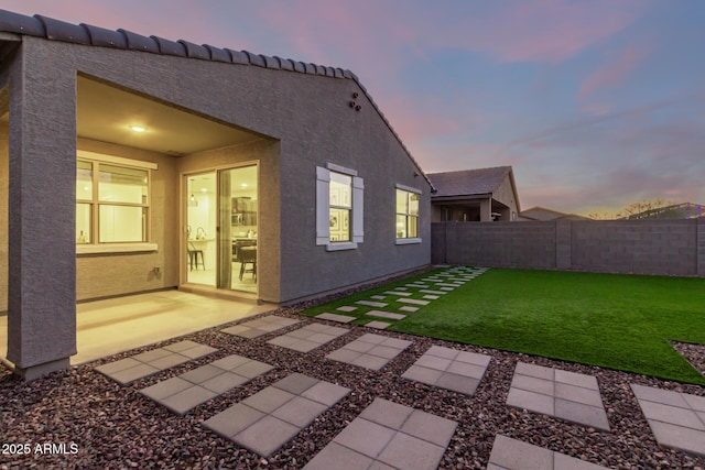 exterior space with a lawn and a patio area