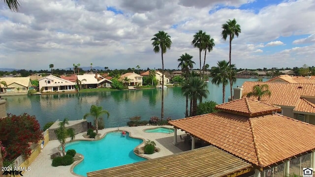 view of pool with a water view and a patio area