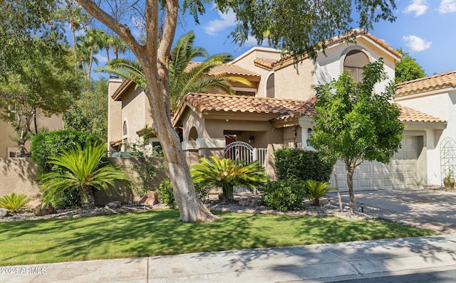 mediterranean / spanish home with a garage and a front yard