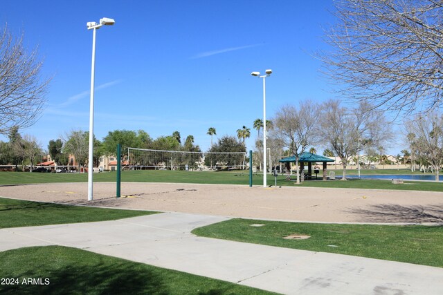 surrounding community with volleyball court and a yard