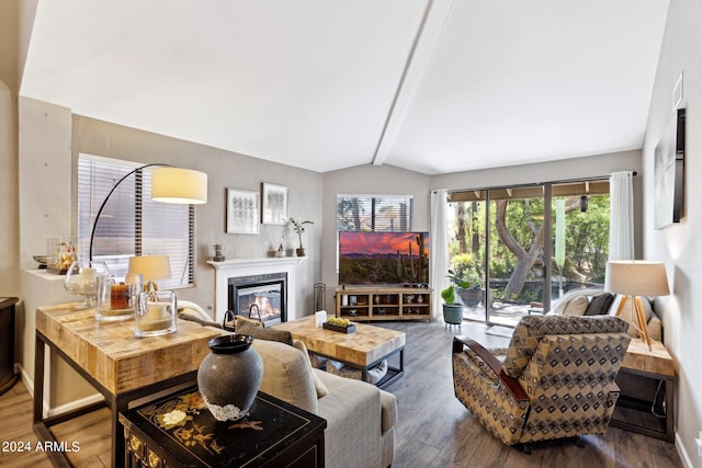 living room with wood-type flooring and vaulted ceiling with beams