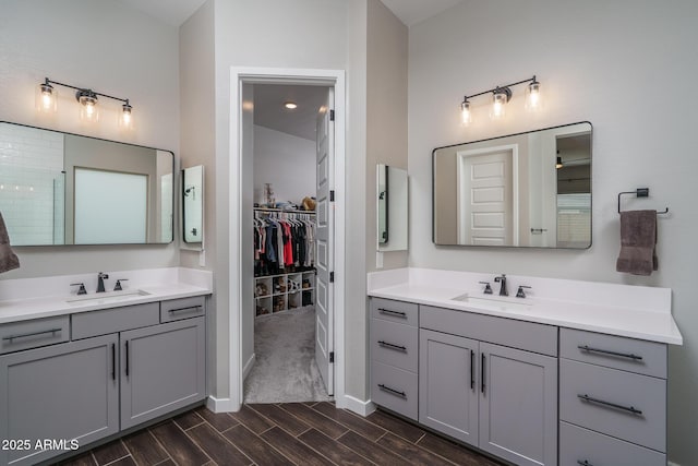 12702 W Sierra Vista Dr, Glendale, AZ 85307 - full bathroom featuring a spacious closet, wood finish floors, two vanities, and a sink