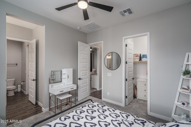 12702 W Sierra Vista Dr, Glendale, AZ 85307 - bedroom featuring visible vents, baseboards, ensuite bath, wood finished floors, and a spacious closet