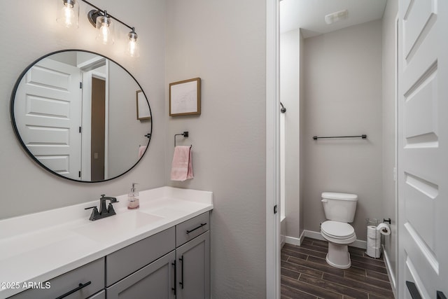 12702 W Sierra Vista Dr, Glendale, AZ 85307 - full bath featuring toilet, vanity, baseboards, and wood finish floors